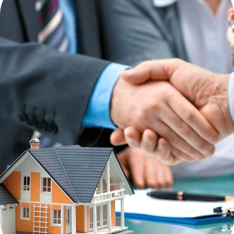 Estate agent shaking hands with customer after contract signature